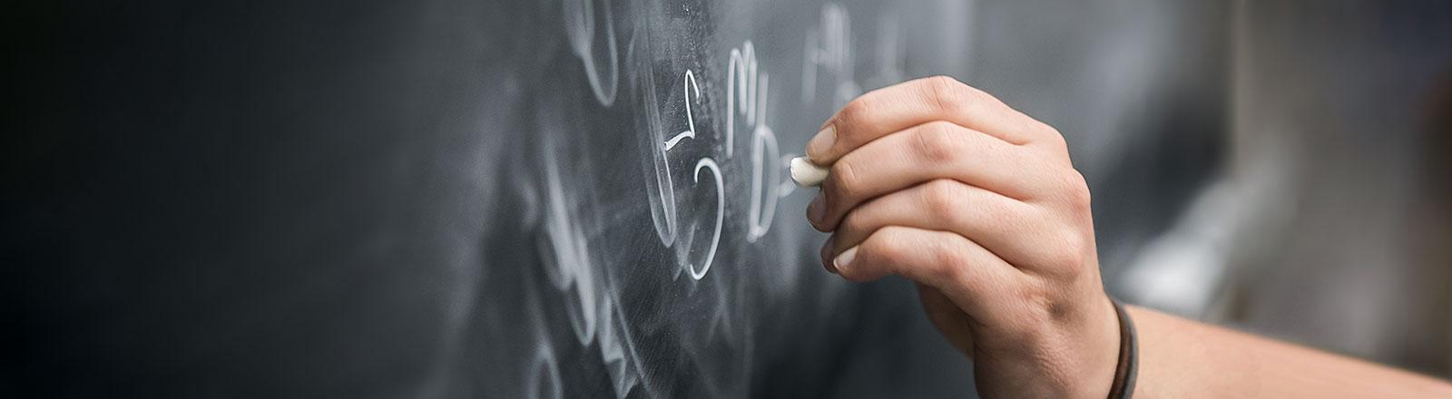 Student pointing towards research presentation